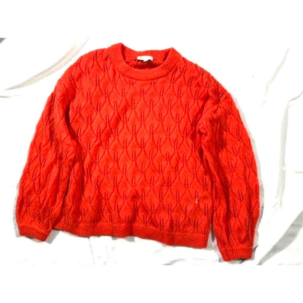 Put the sun in gray day with this bright pointelle sweater in bright orange